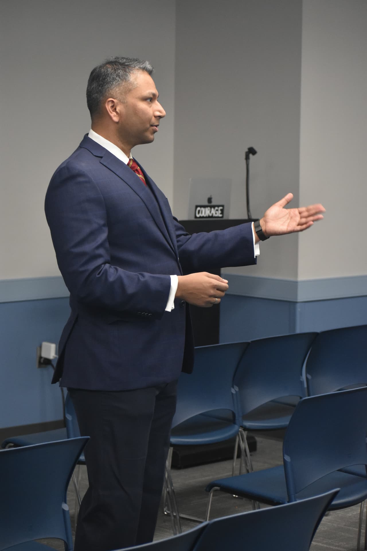 Kireet Kokala speaking to an audience at a lectern